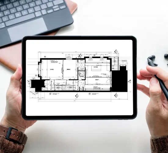A local government worker using iWorQ's software to annotate a blueprint on a tablet.